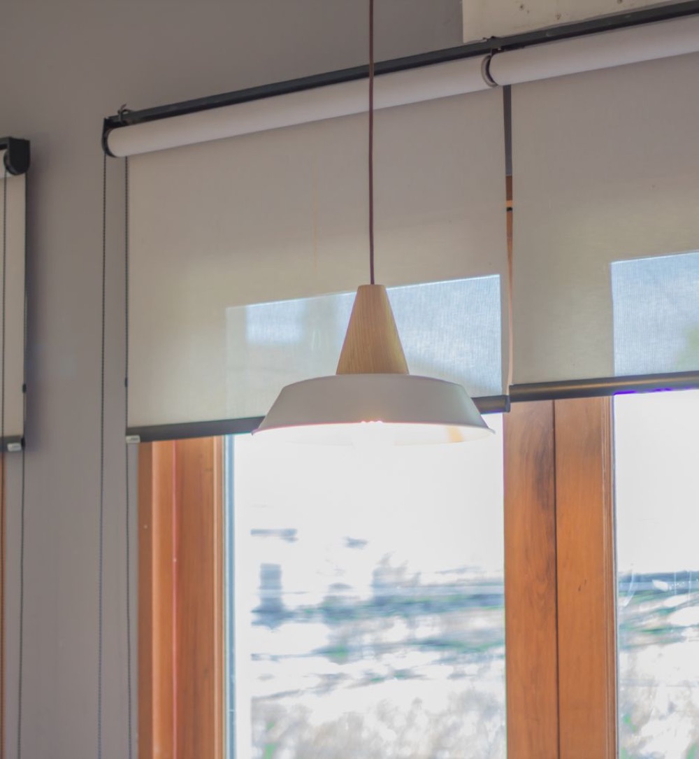 Soft daylight filtered through a roller shade