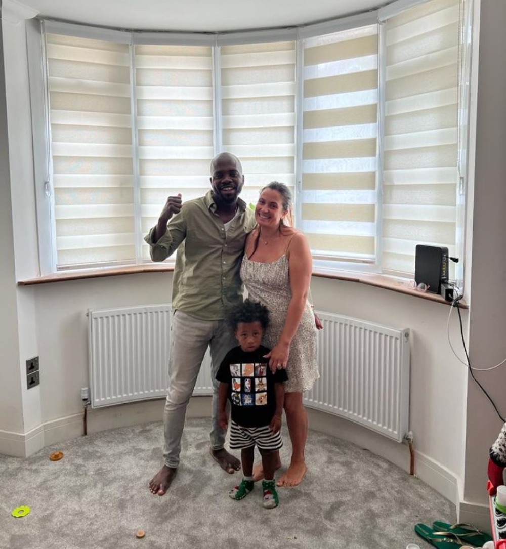 A family by their newly installed bay-window shades